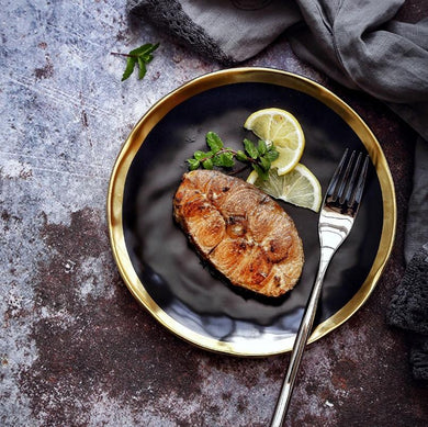 karma dinnerware plate displaying fried fish, boiled eggs and a fork